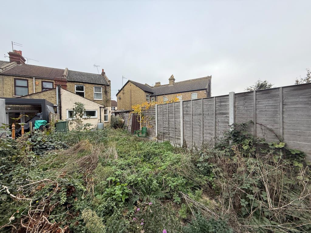Lot: 154 - TWO-BEDROOM END-TERRACE HOUSE FOR IMPROVEMENT - Shot of back of property with first garden view